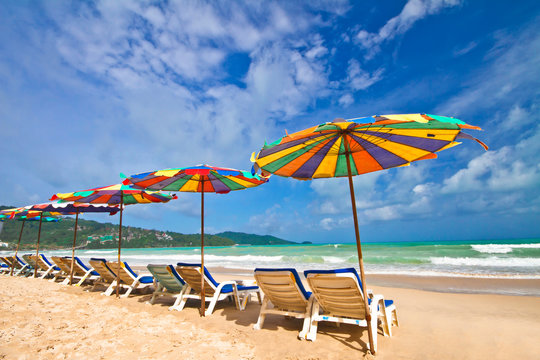 Beach chairs and colorful umbrella on the beach