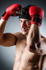 Muscular boxer wiith red gloves