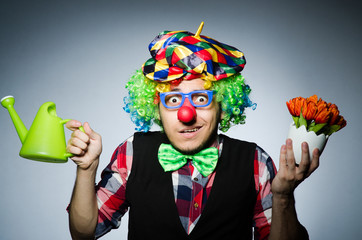 Funny clown with watering can