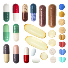 Pills and capsules on white background