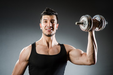 Muscular ripped bodybuilder with dumbbells