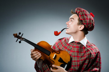Funny scotsman with violin fiddle