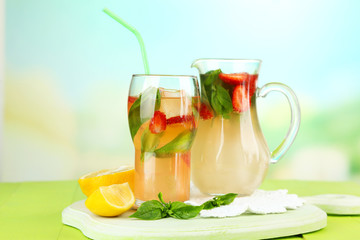 Basil lemonade with strawberry in  jug and glass,
