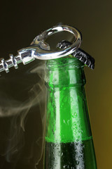 Top of open wet beer bottle on dark background