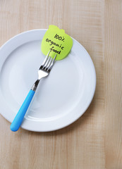 Note paper with message  attached to fork,
