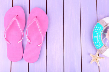 Bright flip-flops on color wooden background