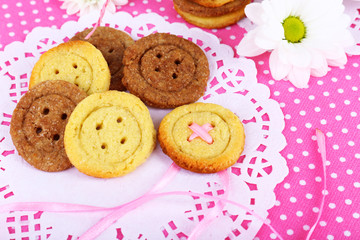 Sugar cookies in shape of buttons on table