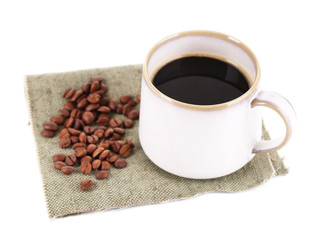 Cup with hot coffee and roasted coffee grains