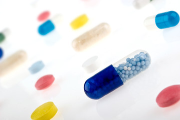 Color pills and capsules background isolated on white background