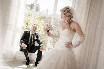 bride  and the groom sitting at a window