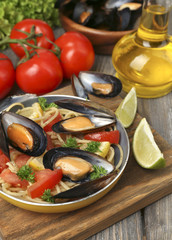 Traditional noodles with mussels on table, close up