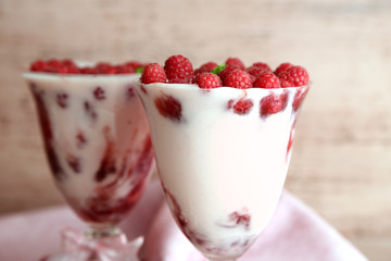 Tasty raspberry dessert with berries on pink wooden background