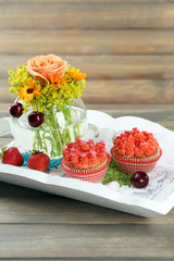 Tasty cupcakes on wooden table, close up