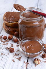 Sweet chocolate cream in jar on table close-up