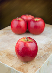 Red apples on chopping board