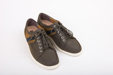 Having stripe pattern on side brown shoes on a white background
