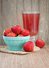 Strawberry drink with fresh strawberry fruits on an old wooden t