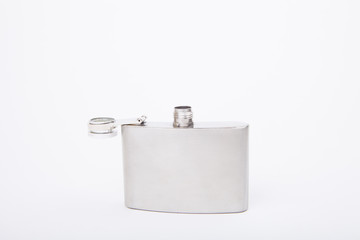 Silver metal hip flask on a white background.