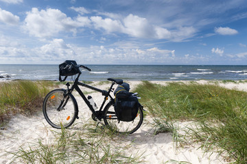 Lonely bike standing on dune on sea coast