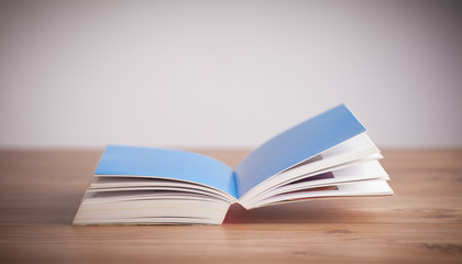 Open book on wooden deck