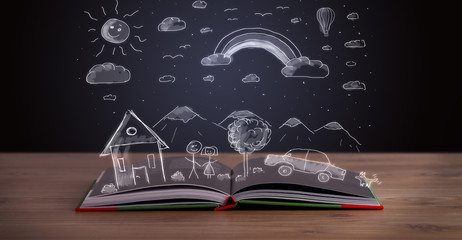 Open book with hand drawn landscape © ra2 studio