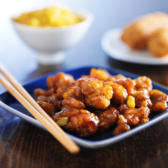 chinese food - orange chicken on blue plate