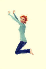 Young happy caucasian woman jumping in the air
