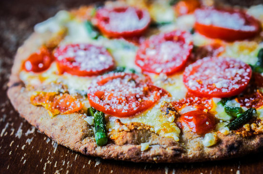 Ancient pizza with tomatoes and asparagus