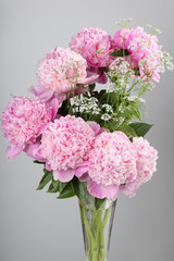 bouquet of pink peonies on a gray background