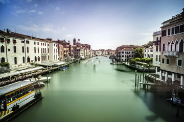 Ancient buildings and boats in the channel in Venice
