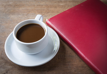 Fototapeta na wymiar Cup of coffee, books, on table wood