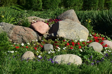 An attractive flowerbed with some rock