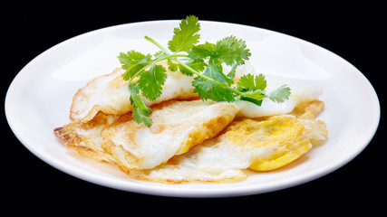 fried egg and  Parsley in the disc/isolation black background
