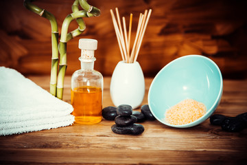 zen basalt stones and spa oil on the wood