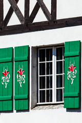 Typical germany windows with green shutters and window box