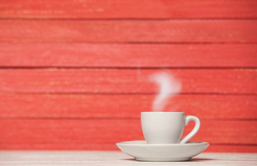 Tea or coffee cup on wooden table.