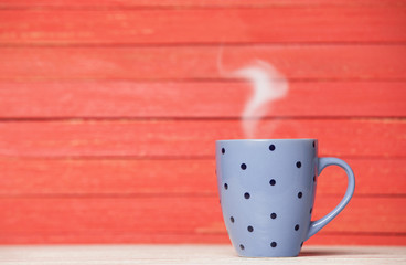 Tea or coffee cup on wooden table.
