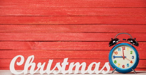 Alarm clock and wooden word Christmas.
