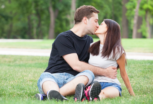 Young Teen Couple Kissing At Outdoor