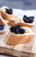 snack on french baguette on a wooden board
