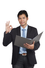 Asian businessman show OK sign with a folder