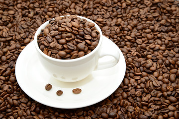 cup with coffee grains on a saucer