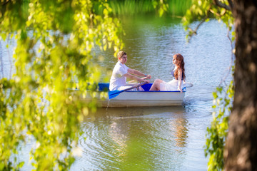 Loving couple in the boat. Summer vacation concept.