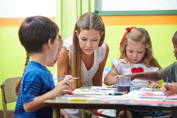 Fototapeta premium Painting in kindergarten with brushes and watercolor