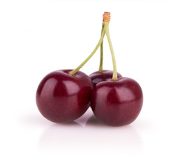 three ripe cherries