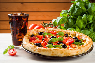 Pizza and coke on wooden table