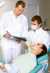 Obraz premium Young woman with dentist in a dental surgery. Healthcare,