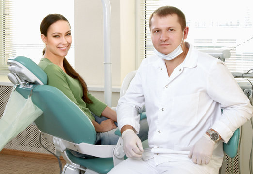Young woman with dentist in a dental surgery. Healthcare,