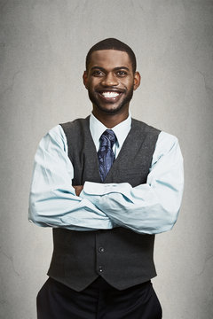 Portrait happy, smiling corporate executive grey wall background
