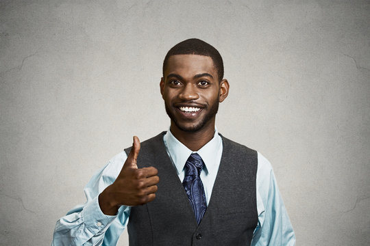 Happy corporate executive giving thumbs up gesture